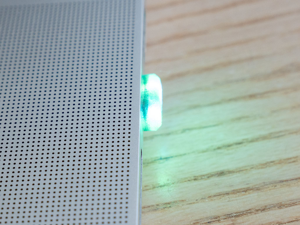 Close-up of SidePulse Dot lit green, barely proud of the laptop edge
